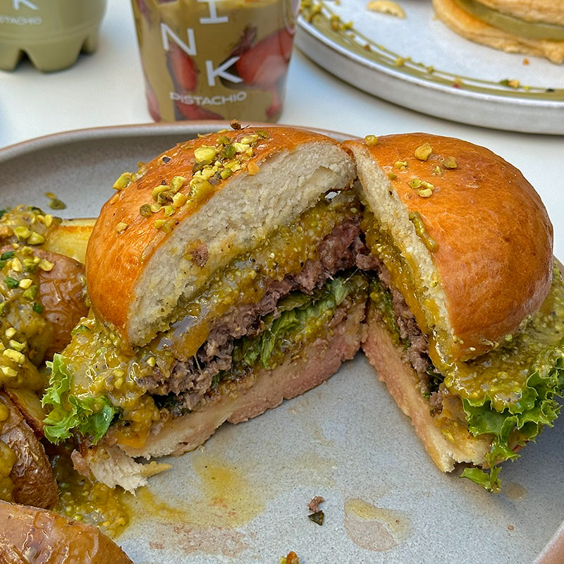 Brunch Budapest signature pistachio burger at Pink Pistachio Brunch with layered flavors