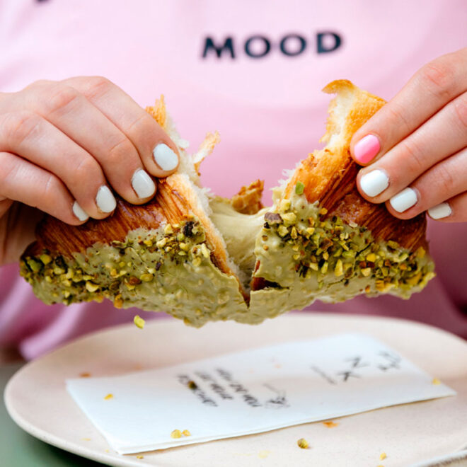 Pistachio-filled pastry being pulled apart in Budapest at Pink Pistachio Brunch
