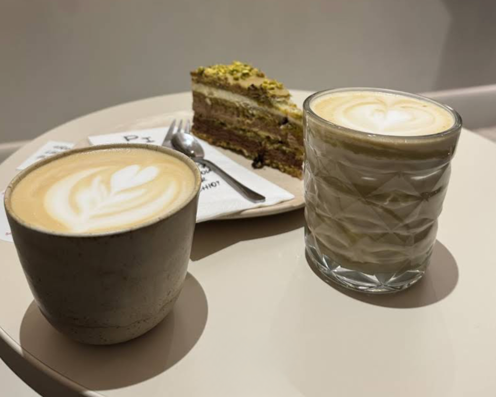 two hot coffee with a slice of sweet cake