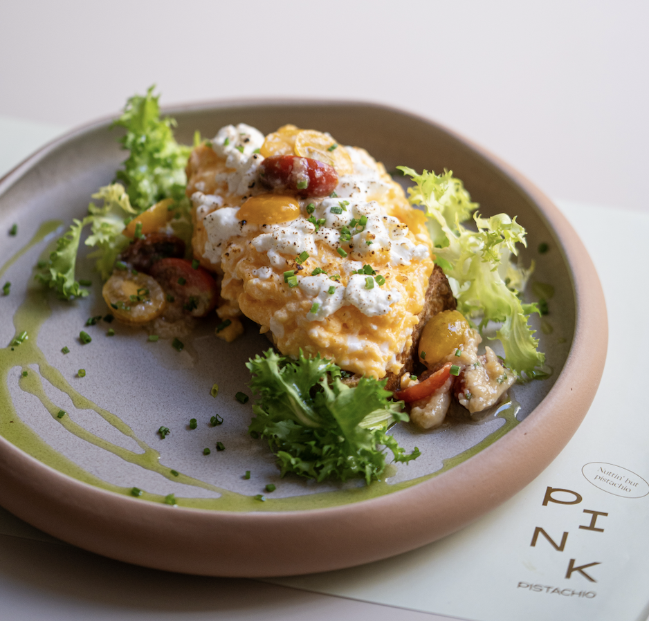 Signature brunch eggs on toast in Budapest at Pink Pistachio Brunch